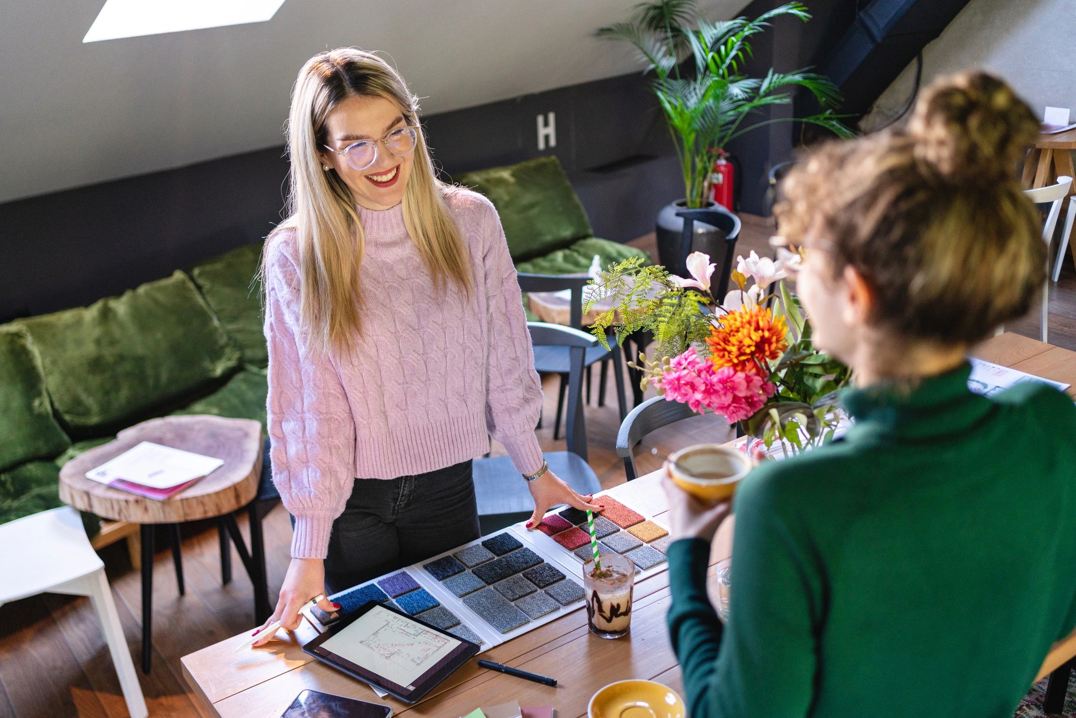 Interior designers collaborating on a project in a modern cafe