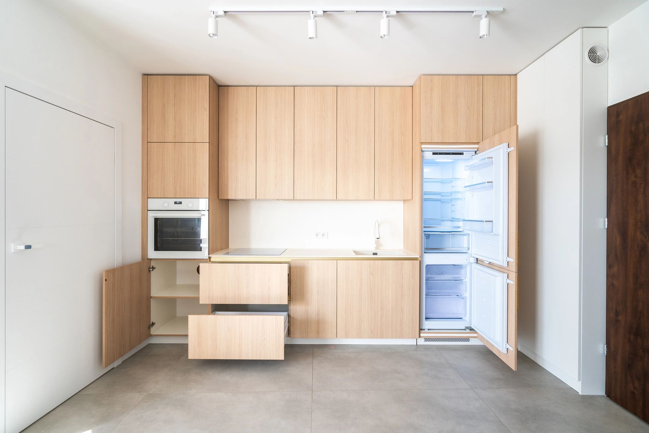 Minimalist wooden kitchen with sleek cabinetry and natural light