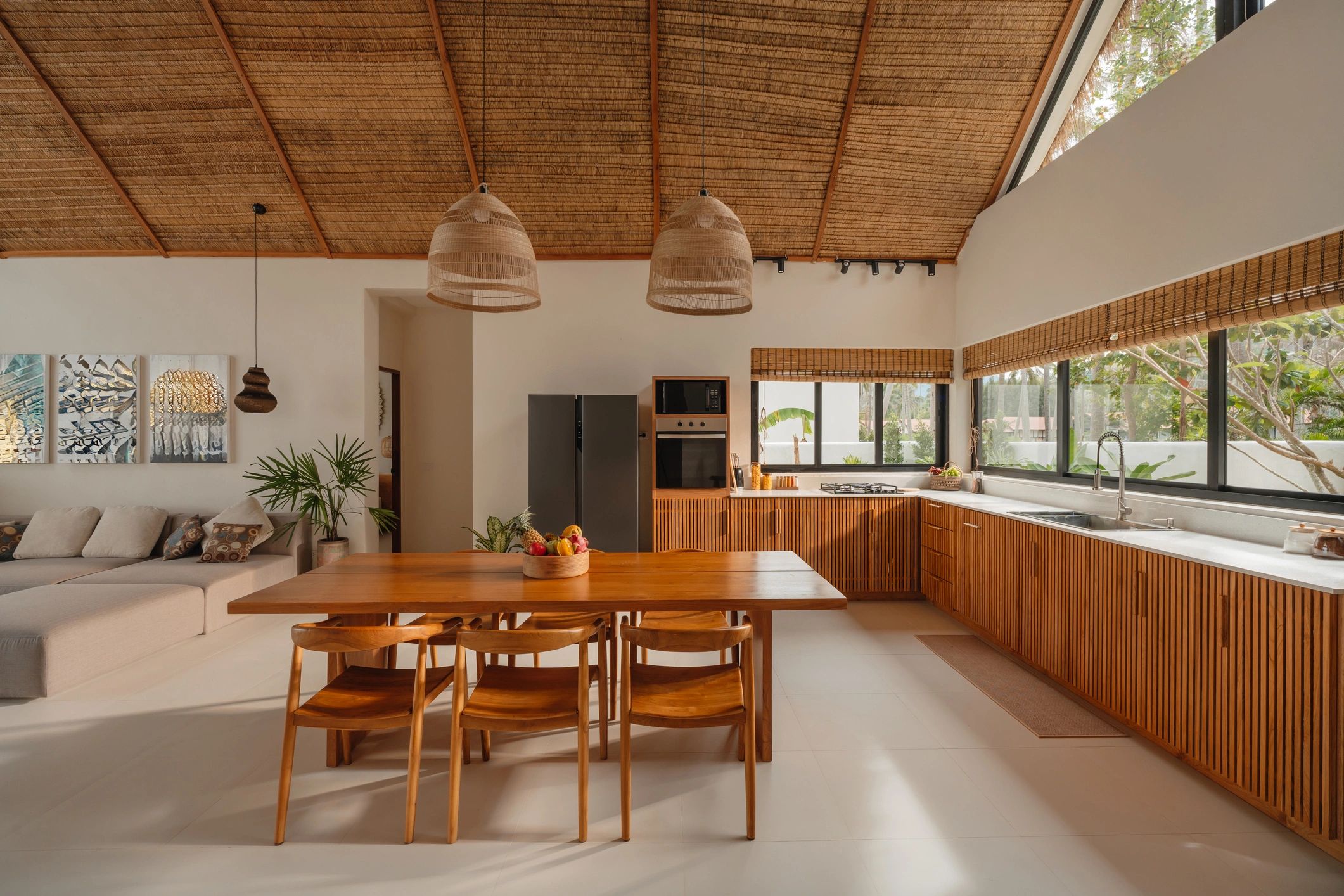 Modern kitchen and dining area with warm wood cabinetry and clean lines