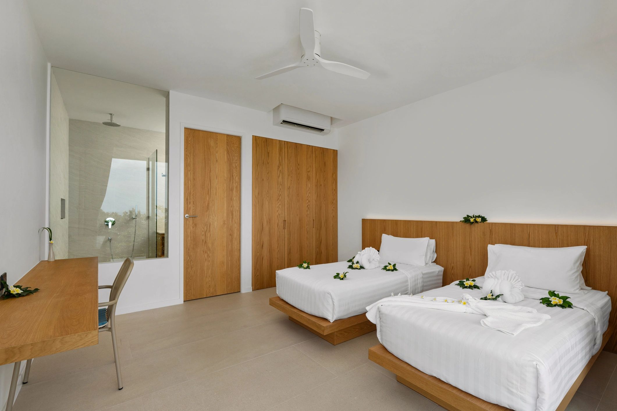Modern minimalist bedroom with twin beds and white linens